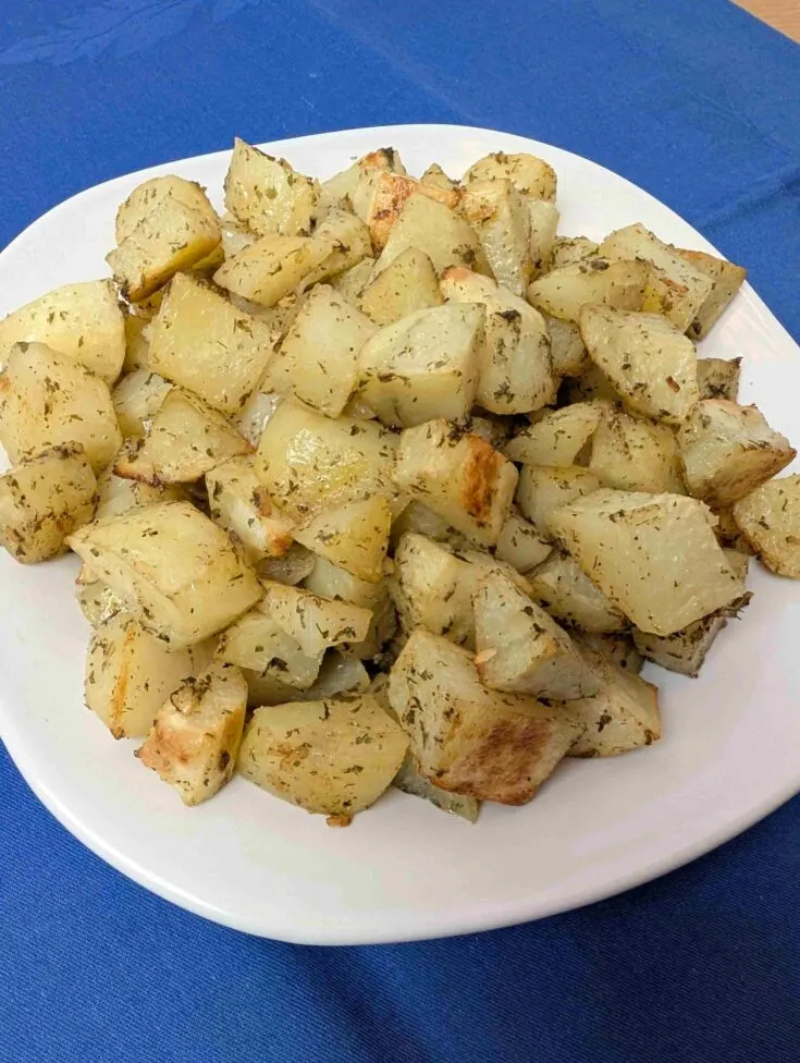 oven roasted ranch potato bites on white plate on blue napkin