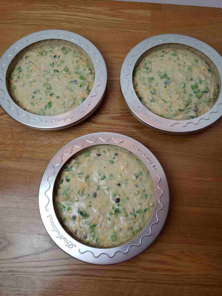 quiches with crust protectors ready to bake
