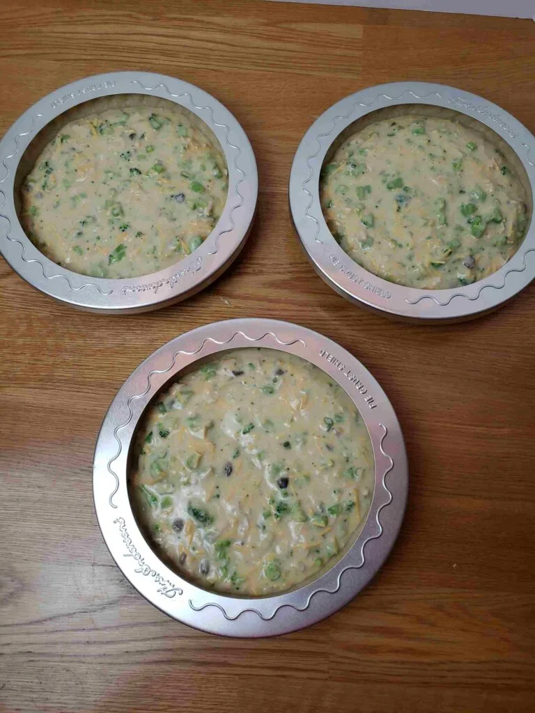quiches with crust protectors ready to bake